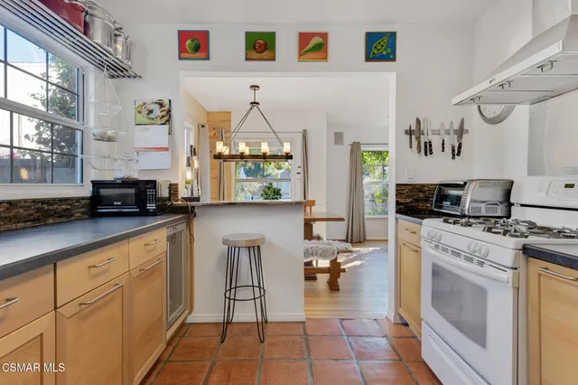 a kitchen with white cabinets and appliances