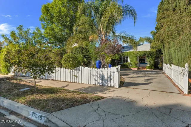 a view of a park with iron fence