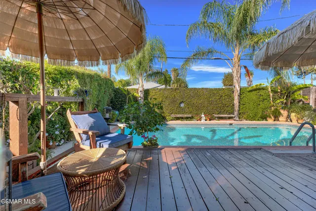 a view of a patio with a table chairs and a potted plant