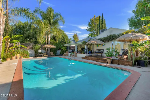 a picture of a room with a white wall and a refrigerator