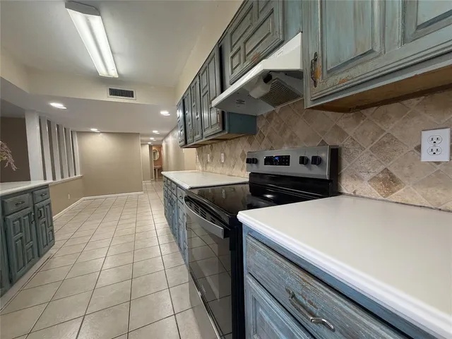 a kitchen with stainless steel appliances granite countertop a sink and cabinets