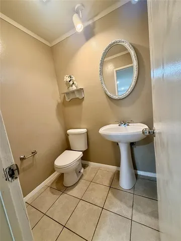 a bathroom with a sink toilet and a mirror