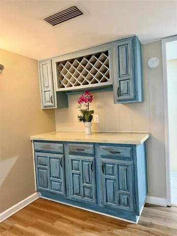 a kitchen with a sink cabinets and wooden floor