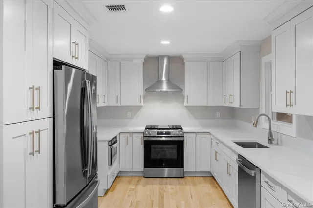 a kitchen with a refrigerator stove and sink
