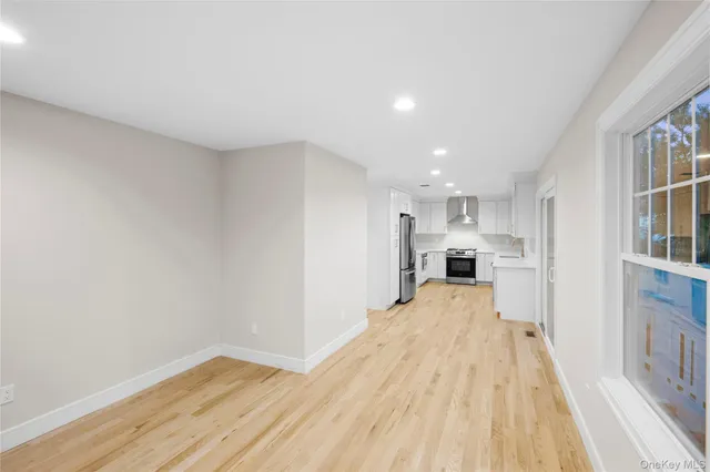 a view of a kitchen with wooden floor and a kitchen
