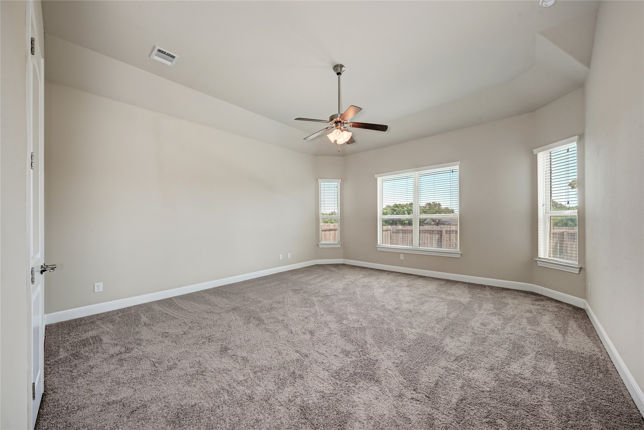 600 Rosedale Boulevard Georgetown, TX 78628 - Photo 15 of 28 An inviting primary bedroom featuring soft carpet and multiple windows for abundant natural illumination.