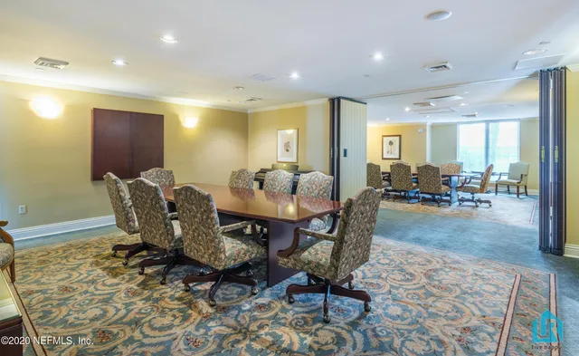 an empty room with wooden floor fireplace and windows