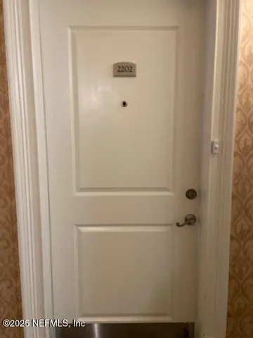 an empty room with a ceiling fan and window