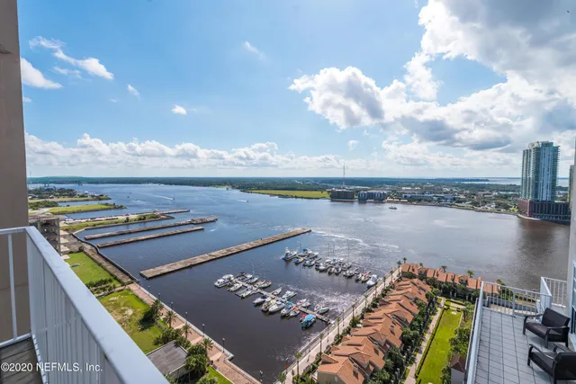 a view of a dining room with furniture wooden floor and chandelier