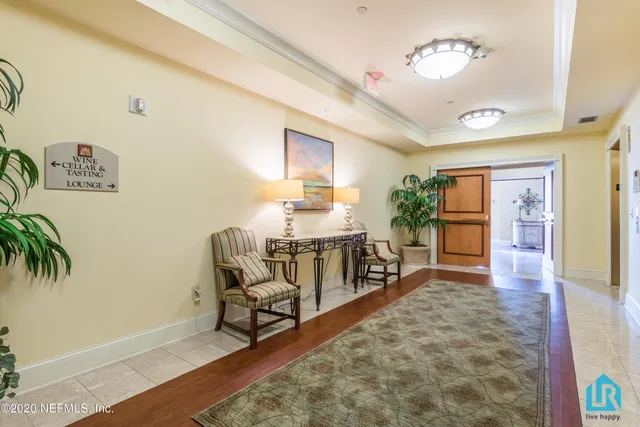 a living room with furniture fireplace and a large window