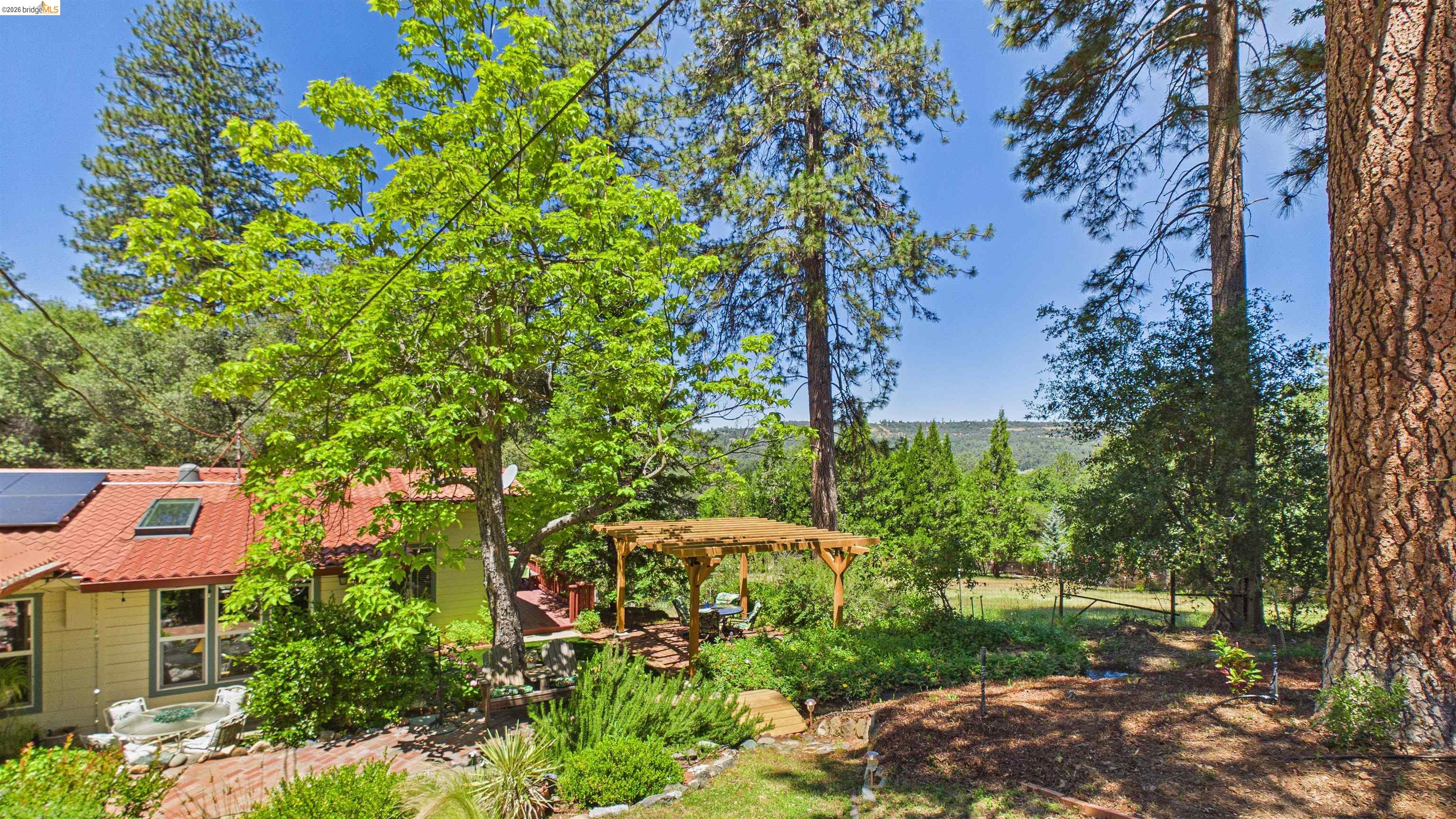 18102 Mt Eaton Road Tuolumne, CA 95379 - Photo 39 of 44 Exterior with a red tile roof, skylight, and solar panels