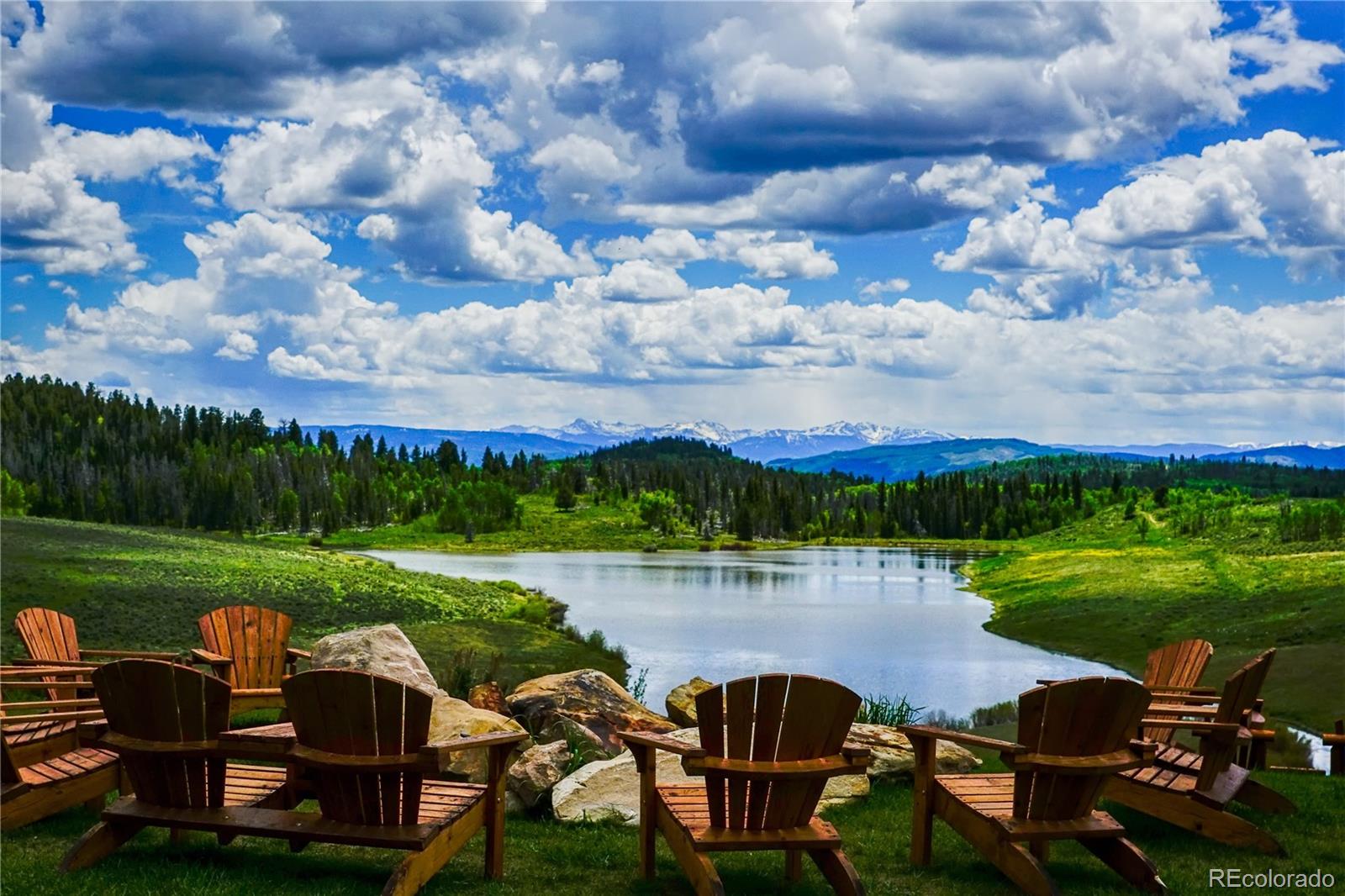 34755 Long Ridge Drive Toponas, CO 80479 - Photo 2 of 40 a view of a lake with lawn chairs and a table