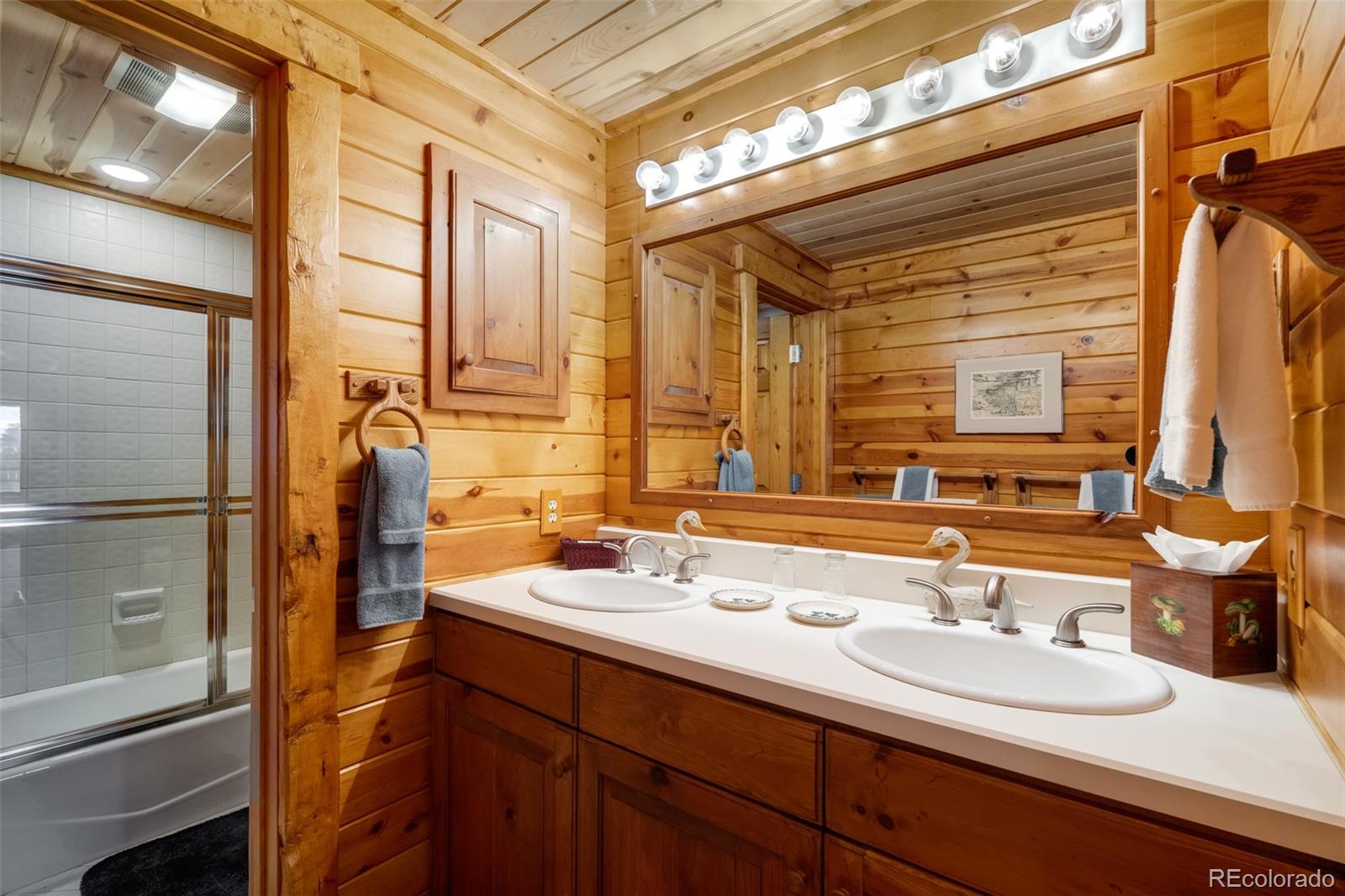 34755 Long Ridge Drive Toponas, CO 80479 - Photo 22 of 40 a bathroom with a double vanity sink and mirror