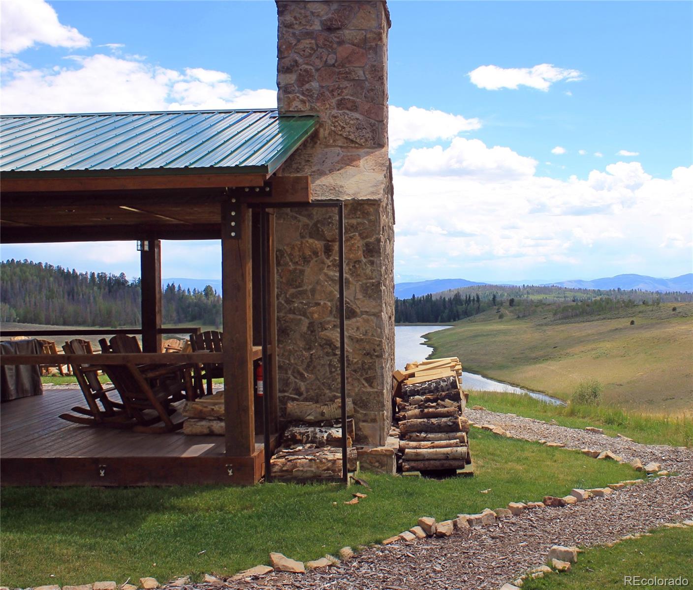 34755 Long Ridge Drive Toponas, CO 80479 - Photo 35 of 40 a front view of a house with a garden and lake view