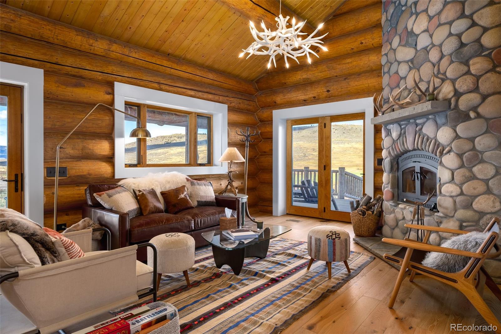 34755 Long Ridge Drive Toponas, CO 80479 - Photo 37 of 40 a living room with furniture a fireplace and a chandelier