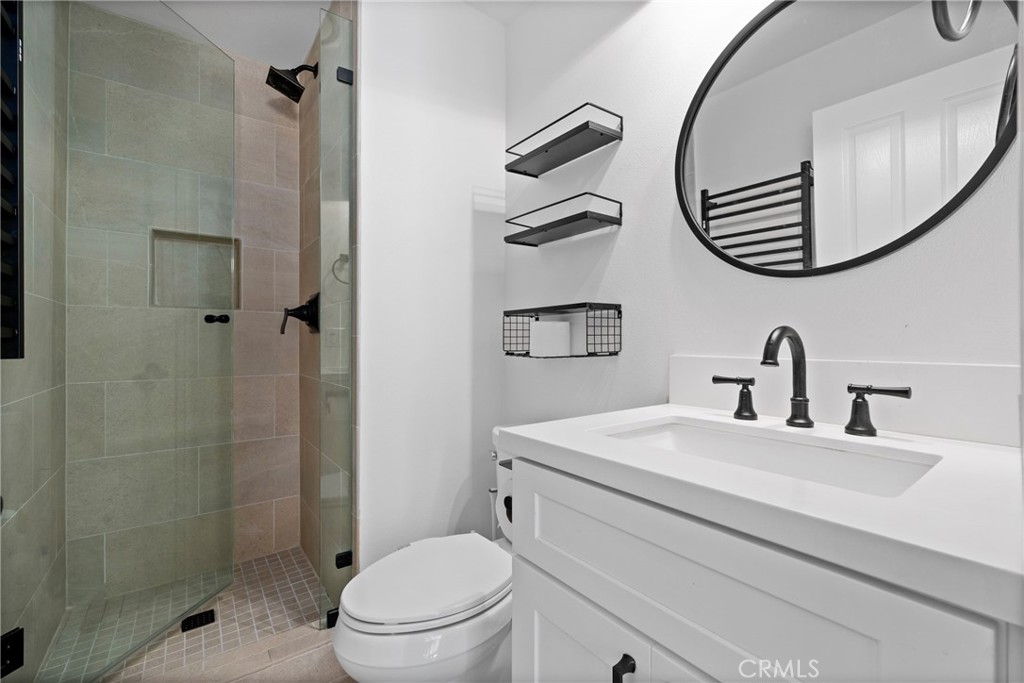 128 White Flower Irvine, CA 92603 - Photo 12 of 13 a bathroom with a sink a toilet and a mirror
