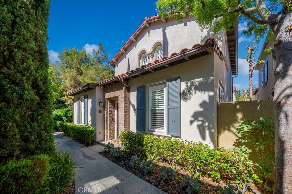 128 White Flower Irvine, CA 92603 - Photo 2 of 13 a front view of a house with a yard
