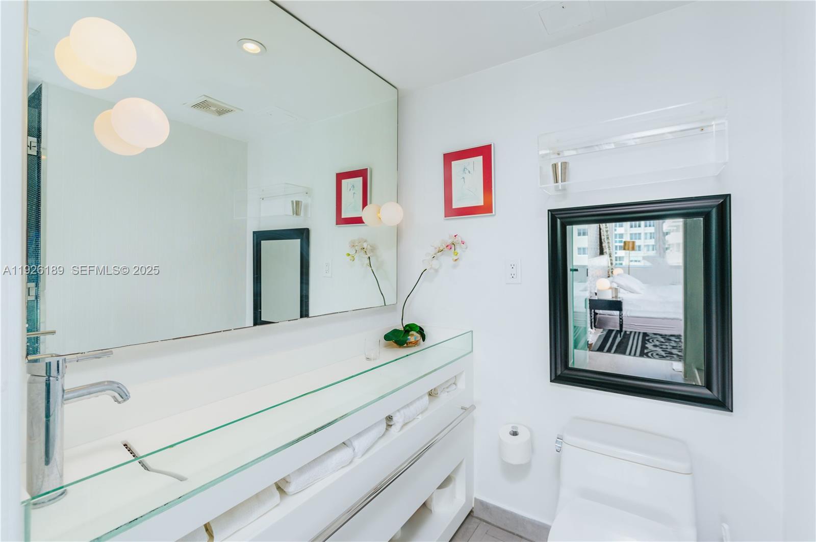 1100 West Avenue, Unit 1004 Miami Beach, FL 33139 - Photo 5 of 22 a bathroom with a sink a mirror and a window