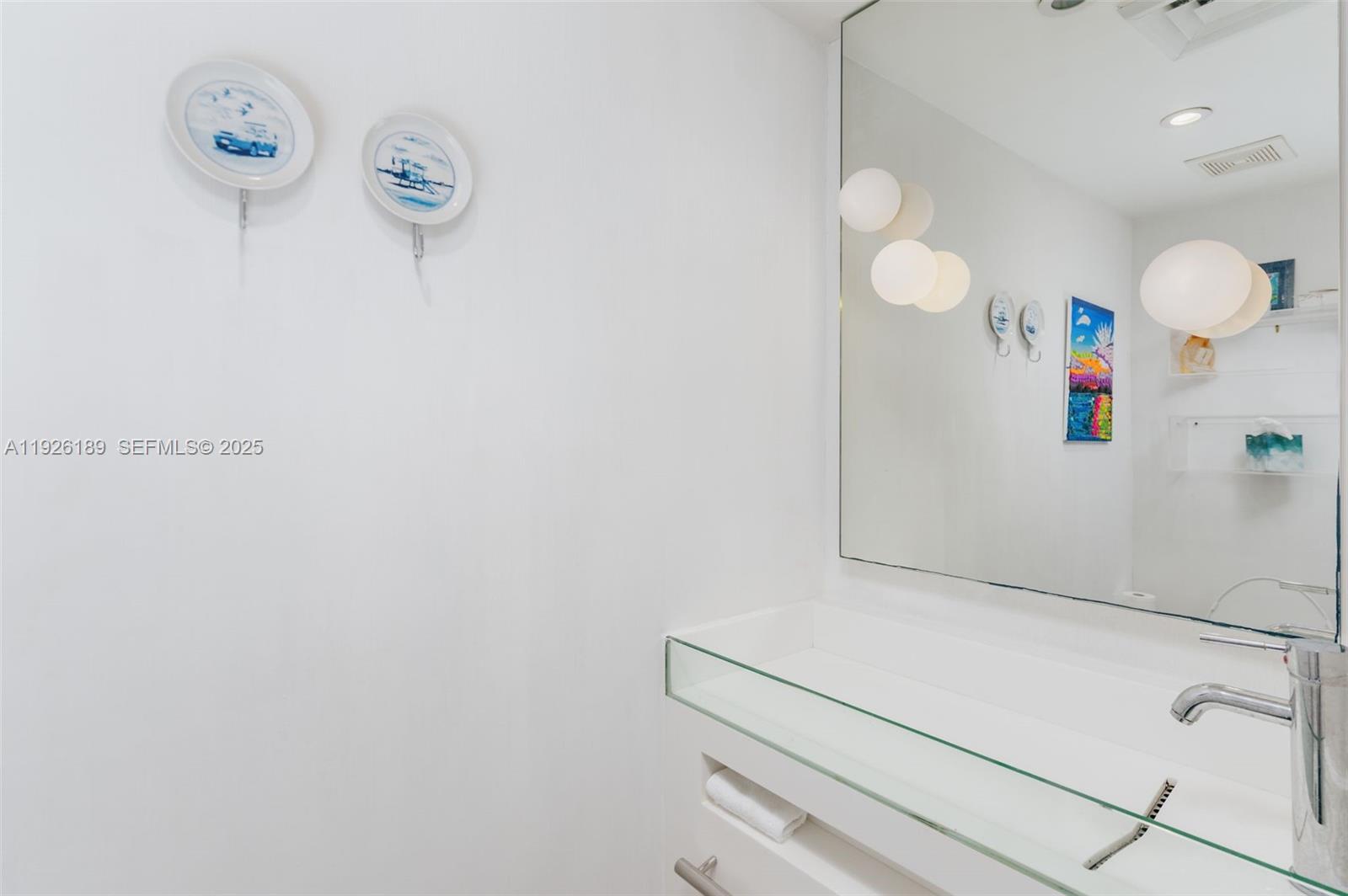 1100 West Avenue, Unit 1004 Miami Beach, FL 33139 - Photo 6 of 22 a bathroom with a sink and a mirror