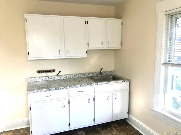 a kitchen with a stove a refrigerator and a window