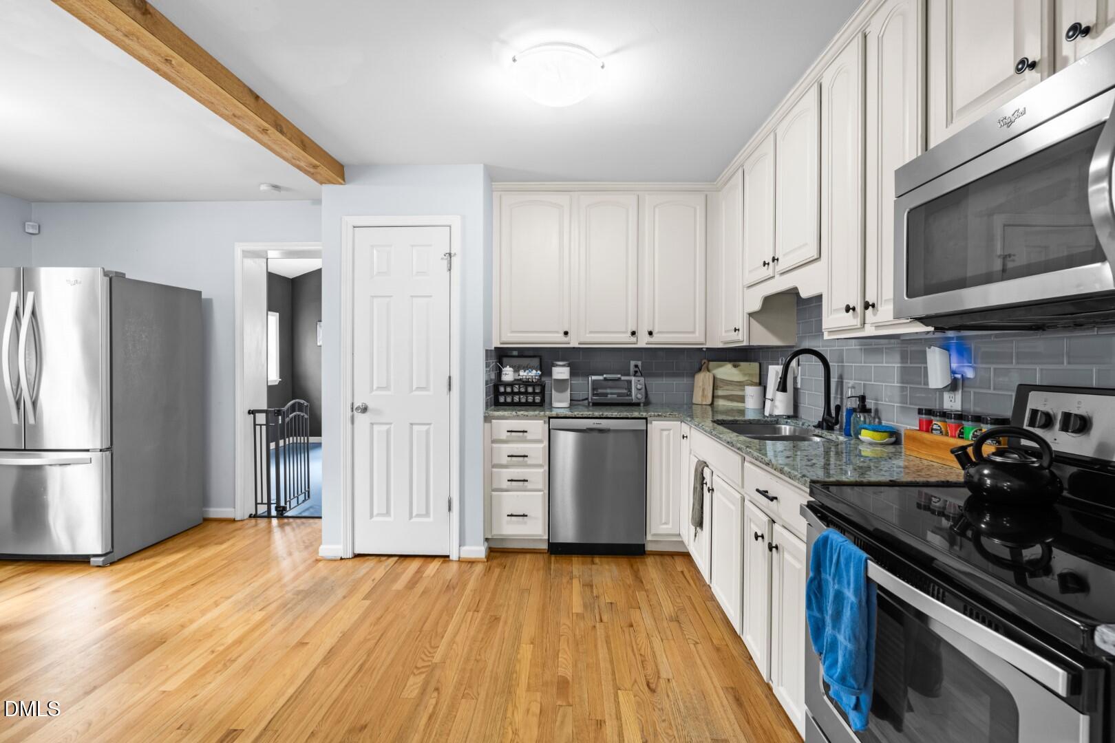 1405 Marlborough Road Raleigh, NC 27610 - Photo 12 of 33 a kitchen with a sink a stove and refrigerator