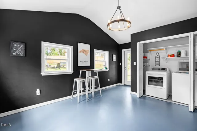 a view of a livingroom with wooden floor and a ceiling fan