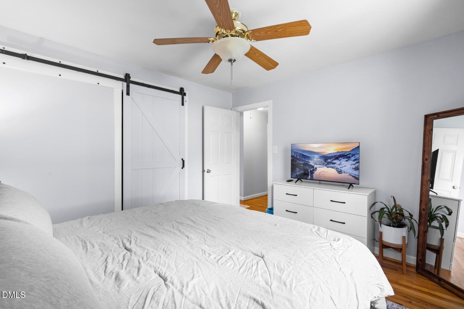 1405 Marlborough Road Raleigh, NC 27610 - Photo 17 of 33 a bedroom with a bed and a flat screen tv