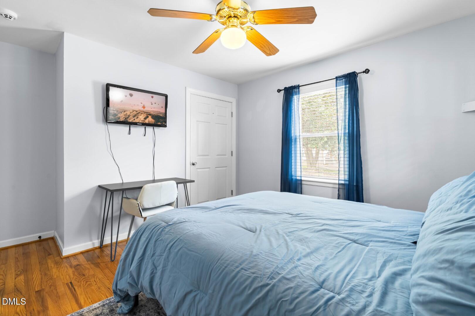 1405 Marlborough Road Raleigh, NC 27610 - Photo 20 of 33 a bedroom with a bed and a chandelier