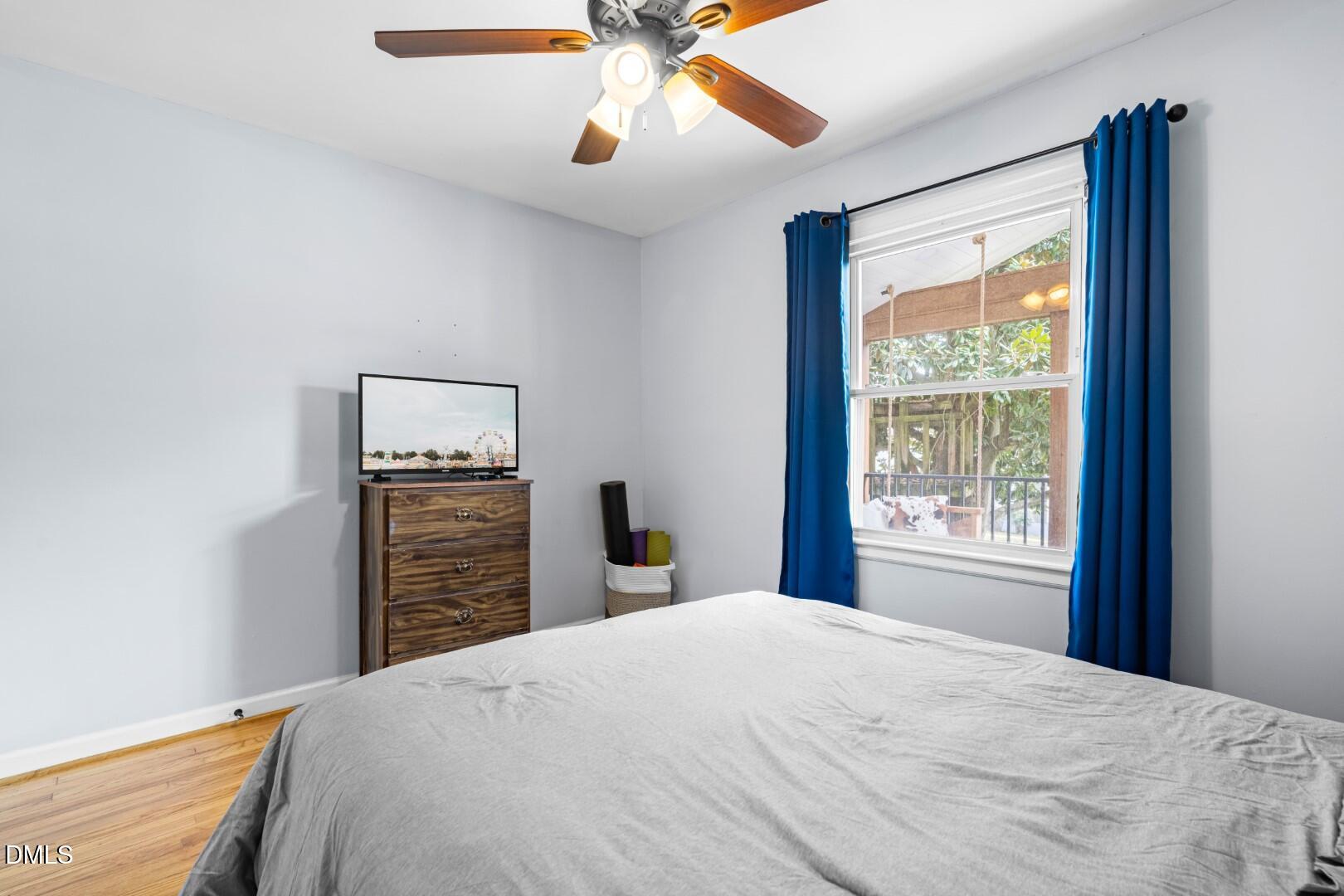 1405 Marlborough Road Raleigh, NC 27610 - Photo 22 of 33 a bedroom with a bed and a chandelier