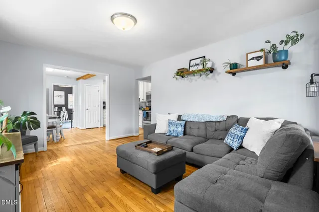 a living room with furniture and wooden floor