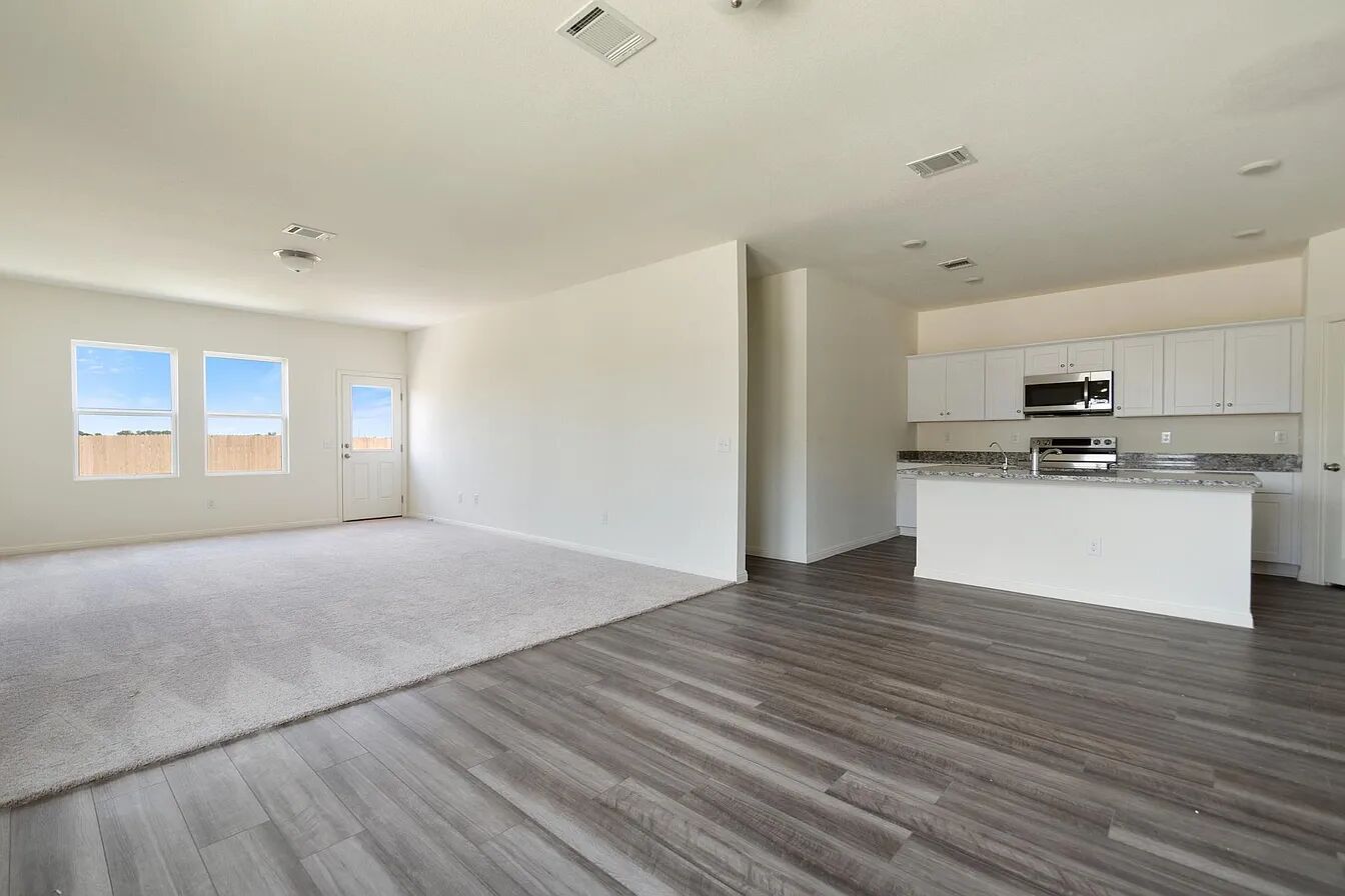101 Aoudad Road Hutto, TX 78634 - Photo 27 of 39 An inviting open-concept layout seamlessly connects the well-lit living area with a contemporary kitchen.