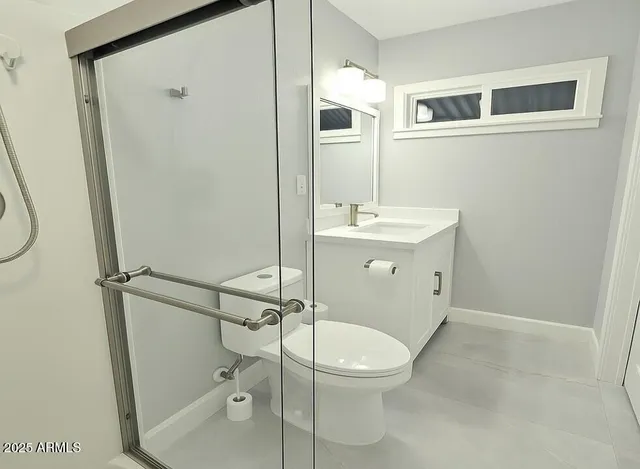 a bathroom with a toilet a sink and shower