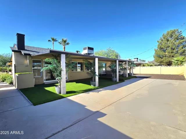 a view of a house with backyard porch and sitting area
