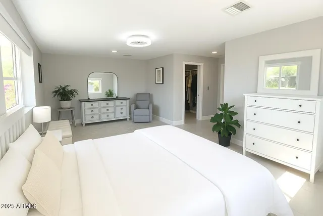 a bedroom with a bed and a dresser