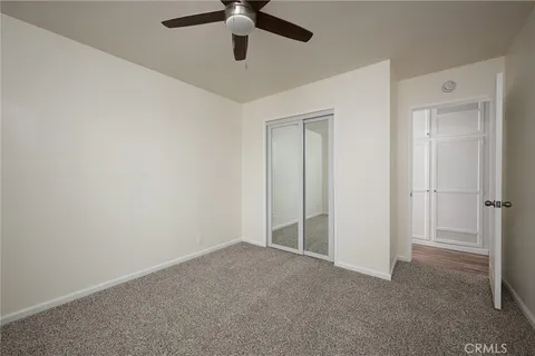 an empty room with a empty space and a ceiling fan