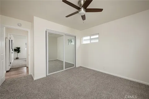 an empty room and chandelier fan