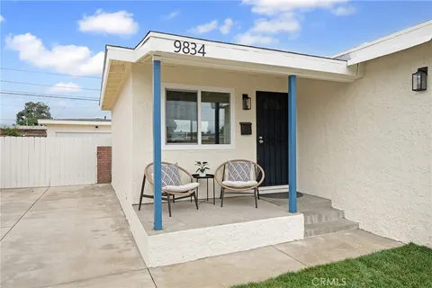 a view of a patio with table and chairs