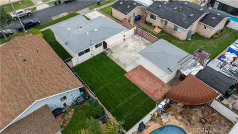 an aerial view of a house with a yard