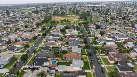an aerial view of residential houses with outdoor space and swimming pool