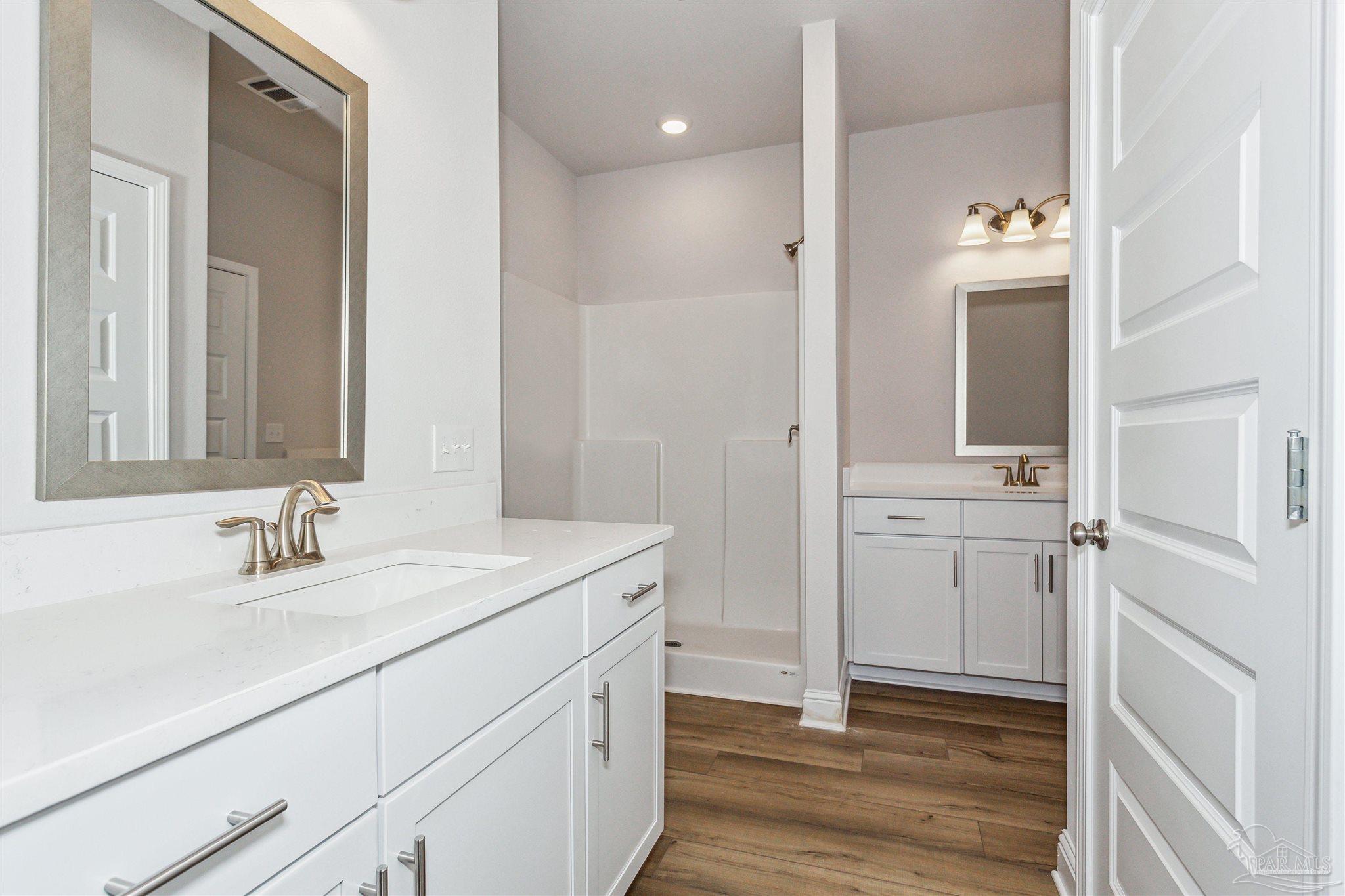 1648 Slate Drive Cantonment, FL 32533 - Photo 19 of 31 a bathroom with a sink and a mirror
