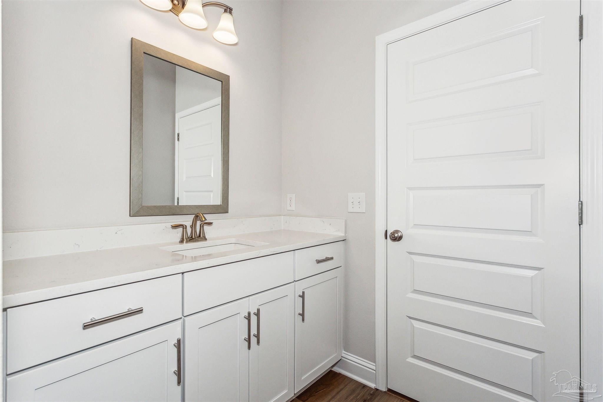 1648 Slate Drive Cantonment, FL 32533 - Photo 20 of 31 a bathroom with a sink and a mirror