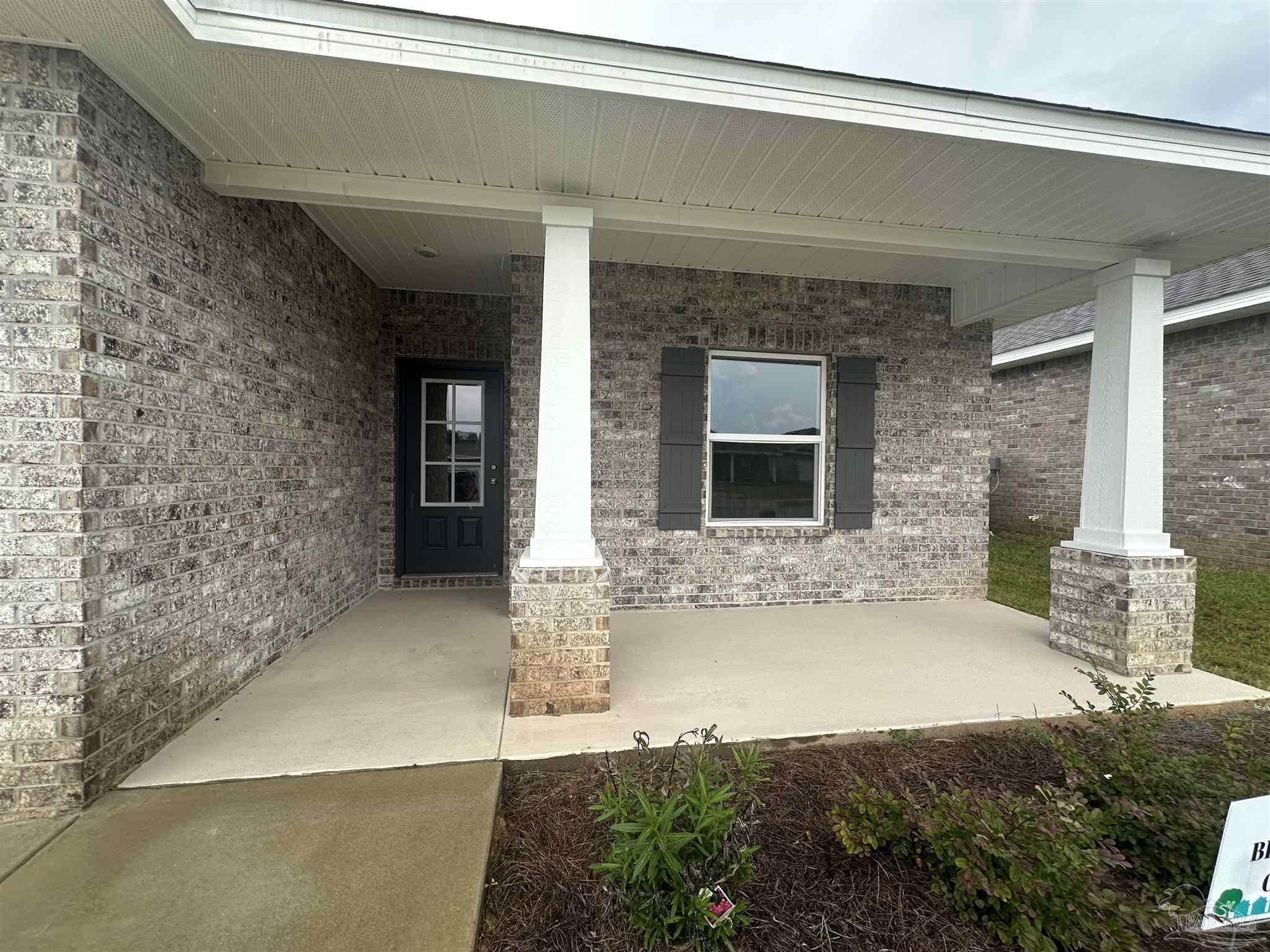 1648 Slate Drive Cantonment, FL 32533 - Photo 2 of 31 a front view of a house with a yard