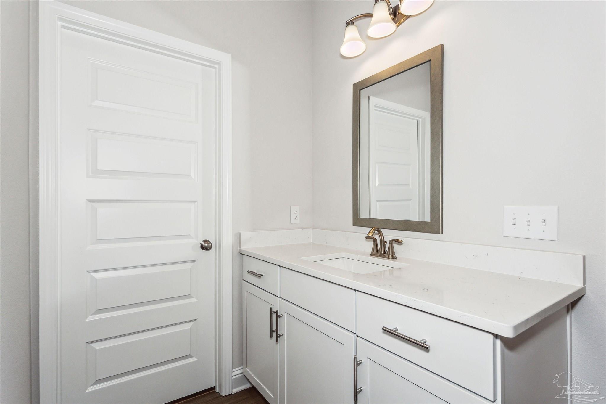 1648 Slate Drive Cantonment, FL 32533 - Photo 21 of 31 a bathroom with a sink and a mirror