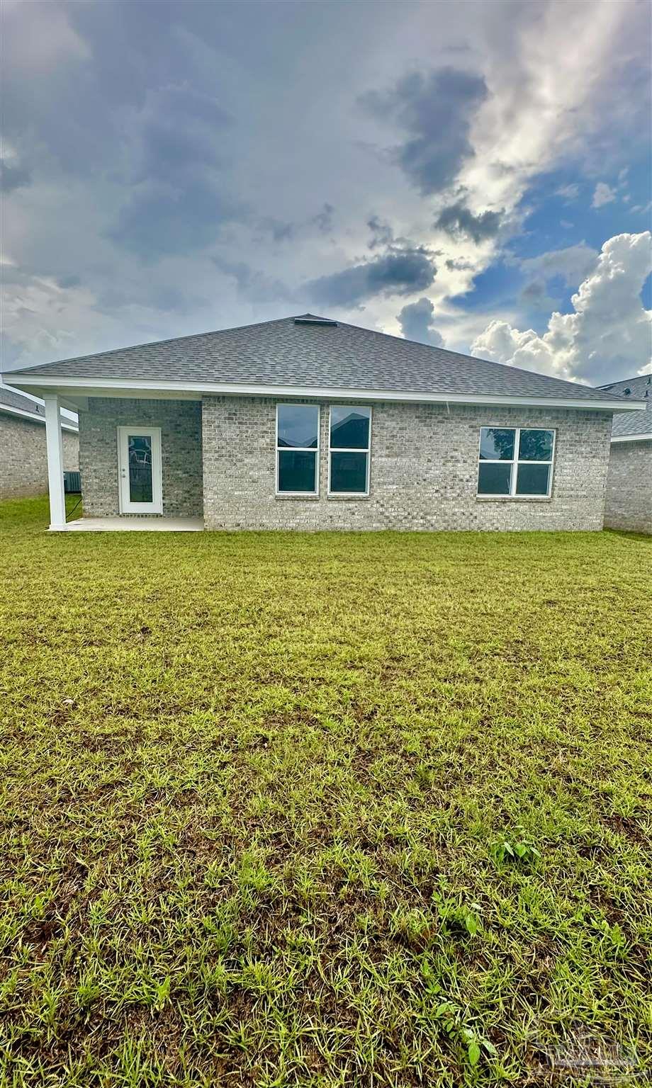 1648 Slate Drive Cantonment, FL 32533 - Photo 30 of 31 a view of a house with a yard