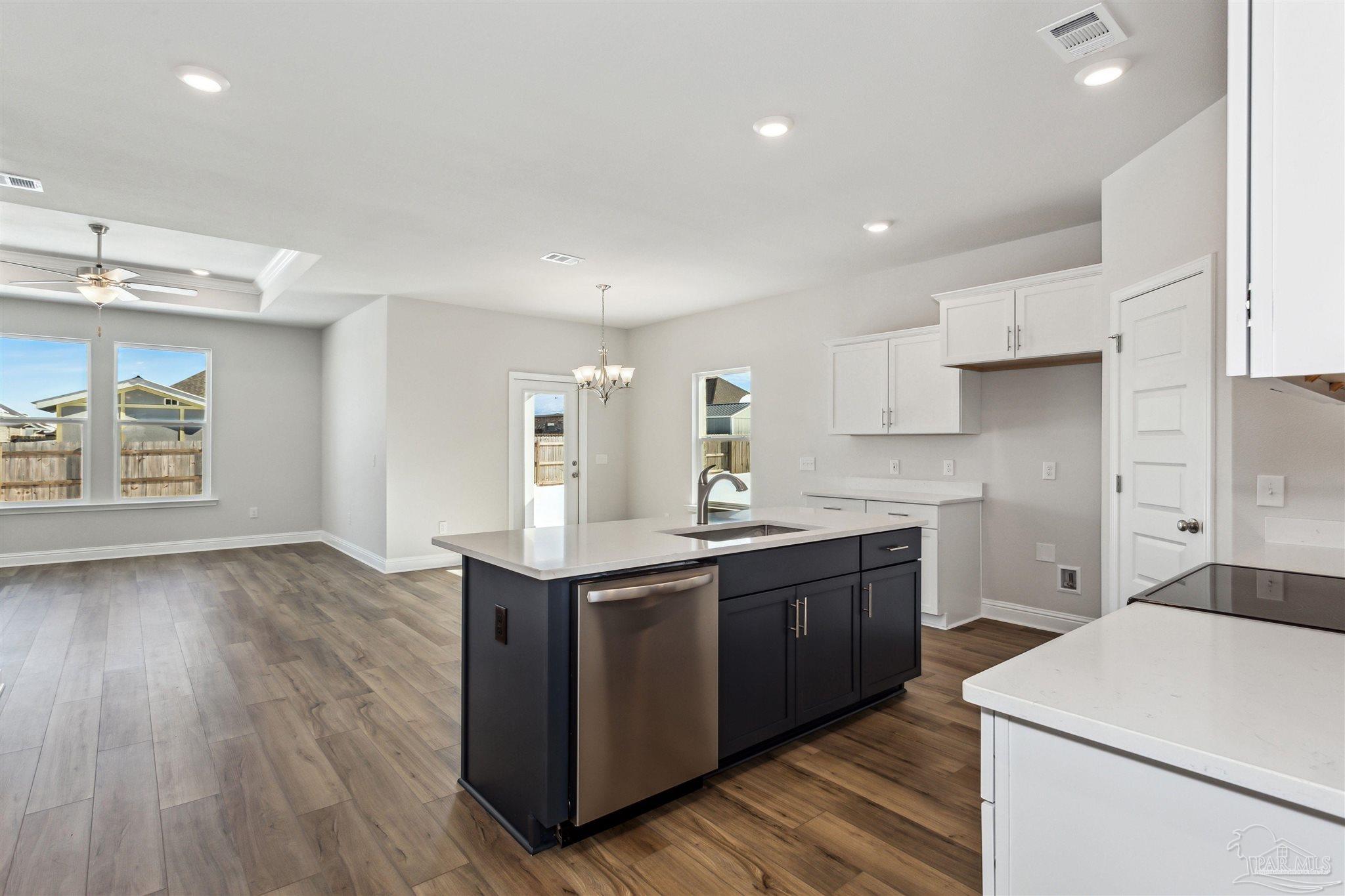 1648 Slate Drive Cantonment, FL 32533 - Photo 4 of 31 a kitchen with a sink cabinets and wooden floor