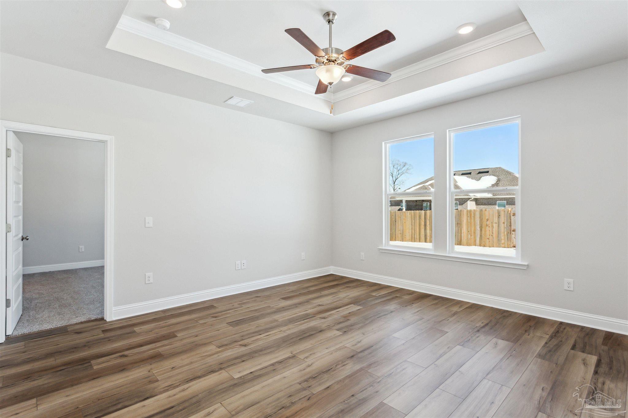 1648 Slate Drive Cantonment, FL 32533 - Photo 9 of 31 an empty room with wooden floor and windows