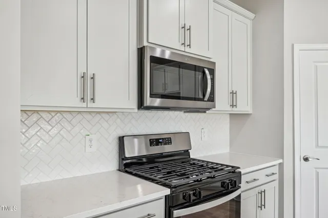 a kitchen with refrigerator and cabinets