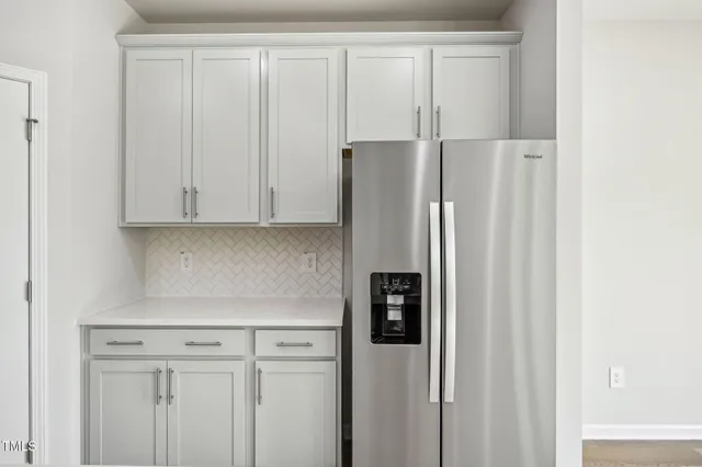 a kitchen with stainless steel appliances a refrigerator sink and microwave