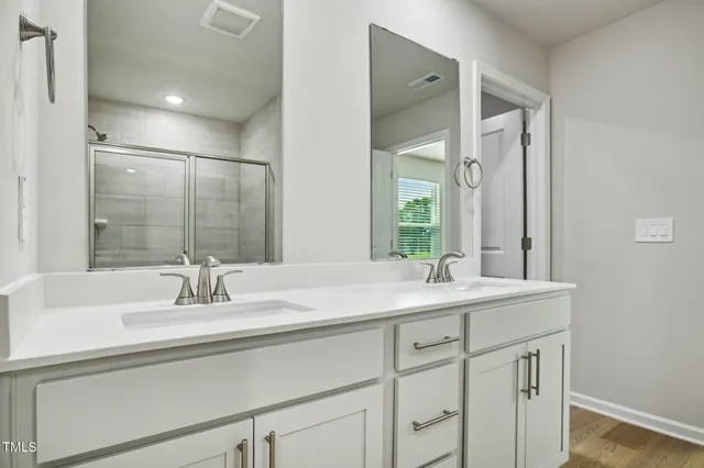 a bathroom with a glass shower door