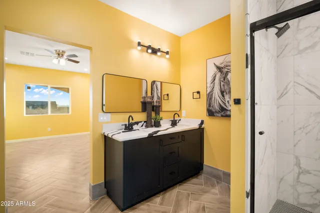 a bathroom with a double vanity sink a mirror and a shower